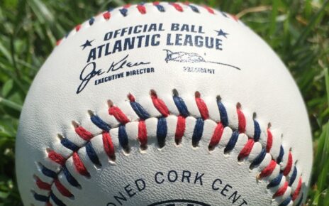 A red, shite, and blue laced baseball used by the Atlantic League