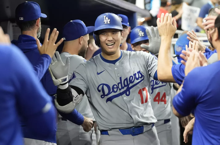 Shohei Ohtani celebrating in the Dodgers dugout.