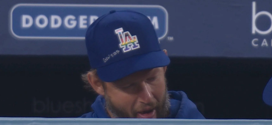 Still of a Fox Sports West broadcast that shows Clayton Kershaw's Pride Night hat with a bible verse written on it.